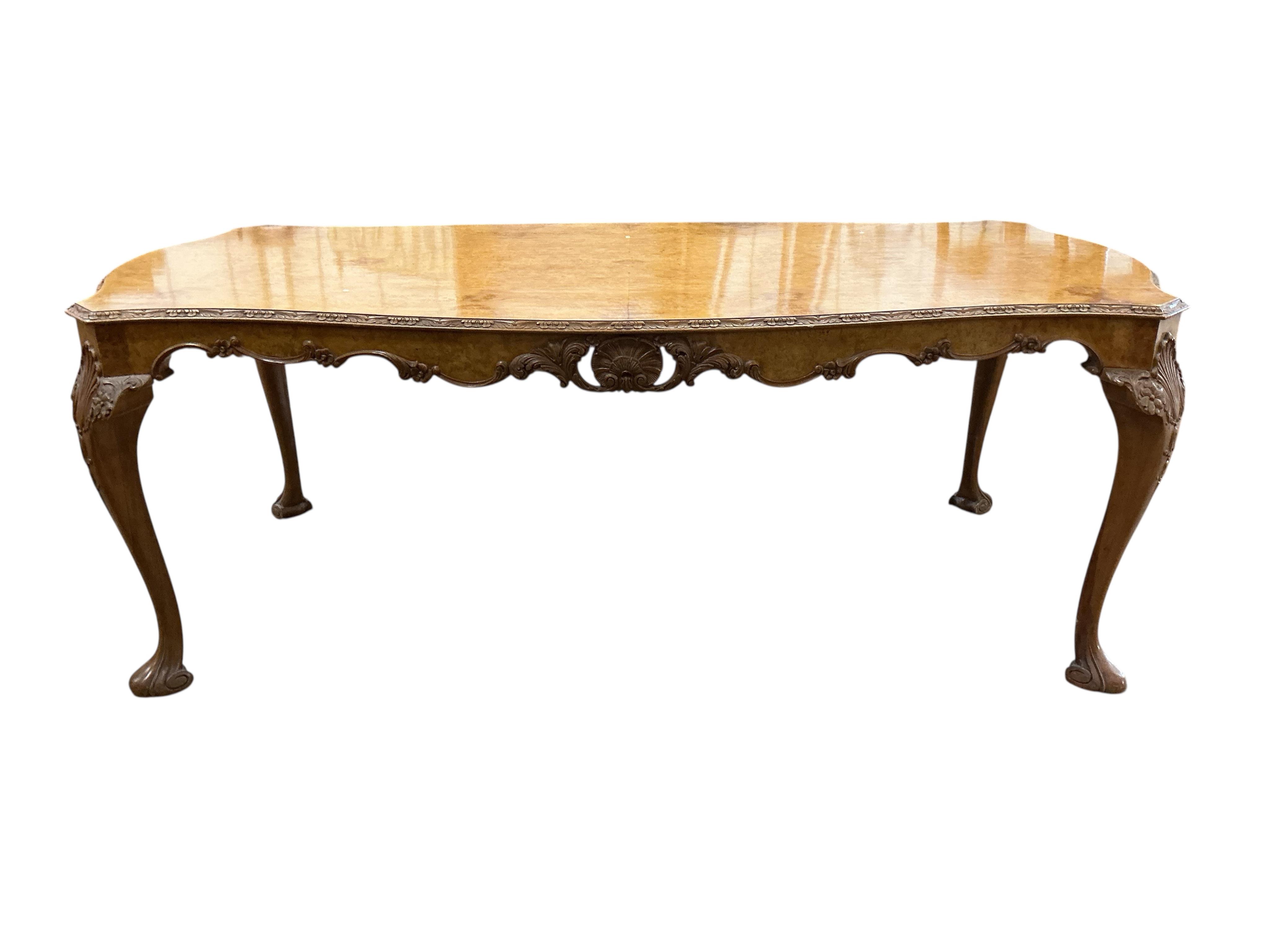 A Queen Anne Revival rectangular walnut dining table, width 210cm, depth 104cm, height 76cm together with six matching upholstered dining chairs